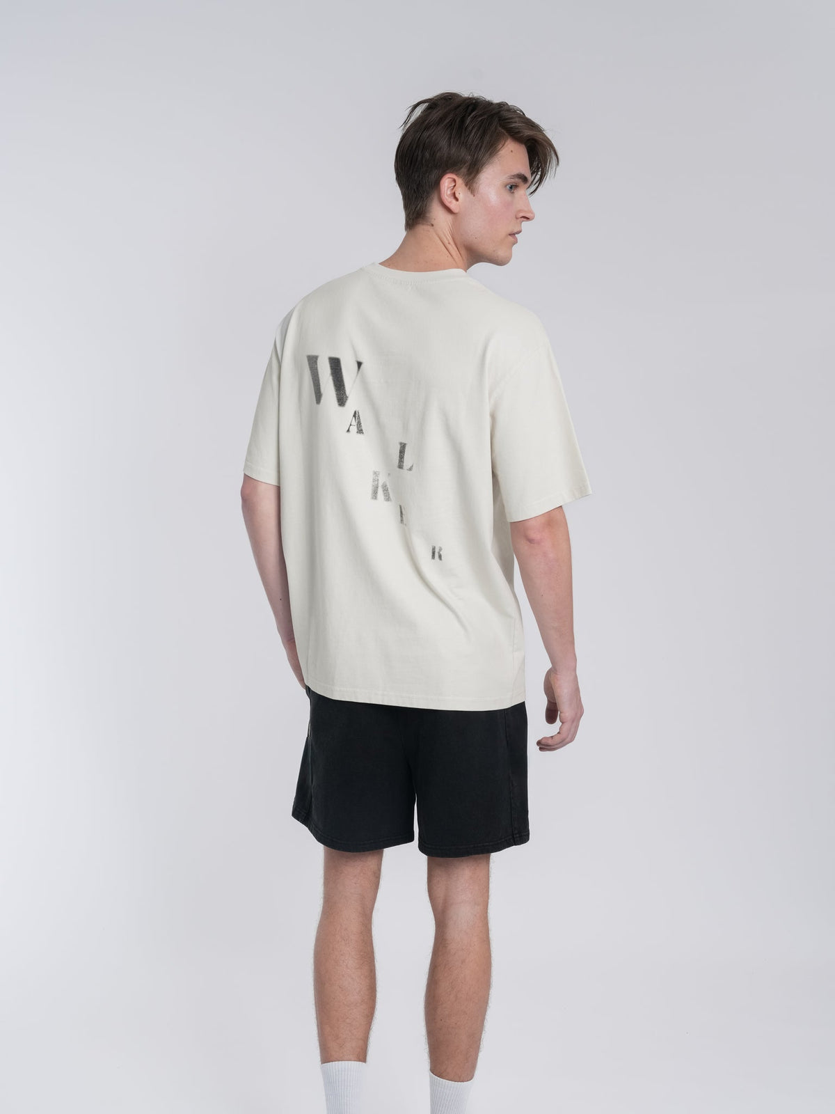 Alan Walker Off-White Walker Tee rear three-quarter view, faded WALKER back print on soft off-white cotton
