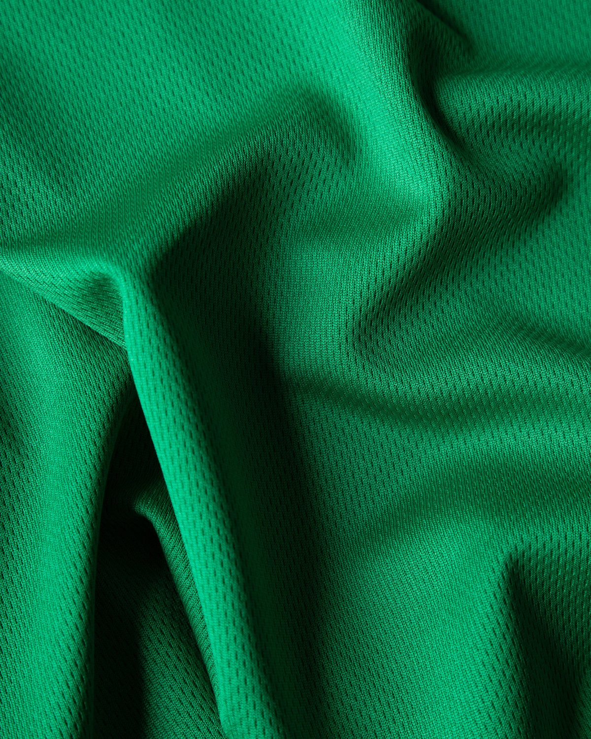 Alan Walker Creator Circle Tribe Jersey textile detail, honeycomb knit green mesh catching the studio light