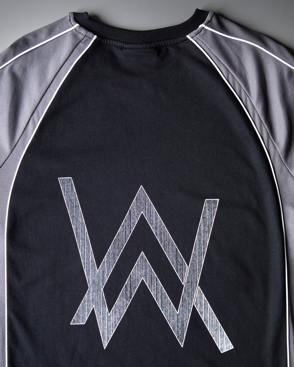 Alan Walker Springseeker Sports T-Shirt back close-up, oversized silver AW logo across the black jersey panel