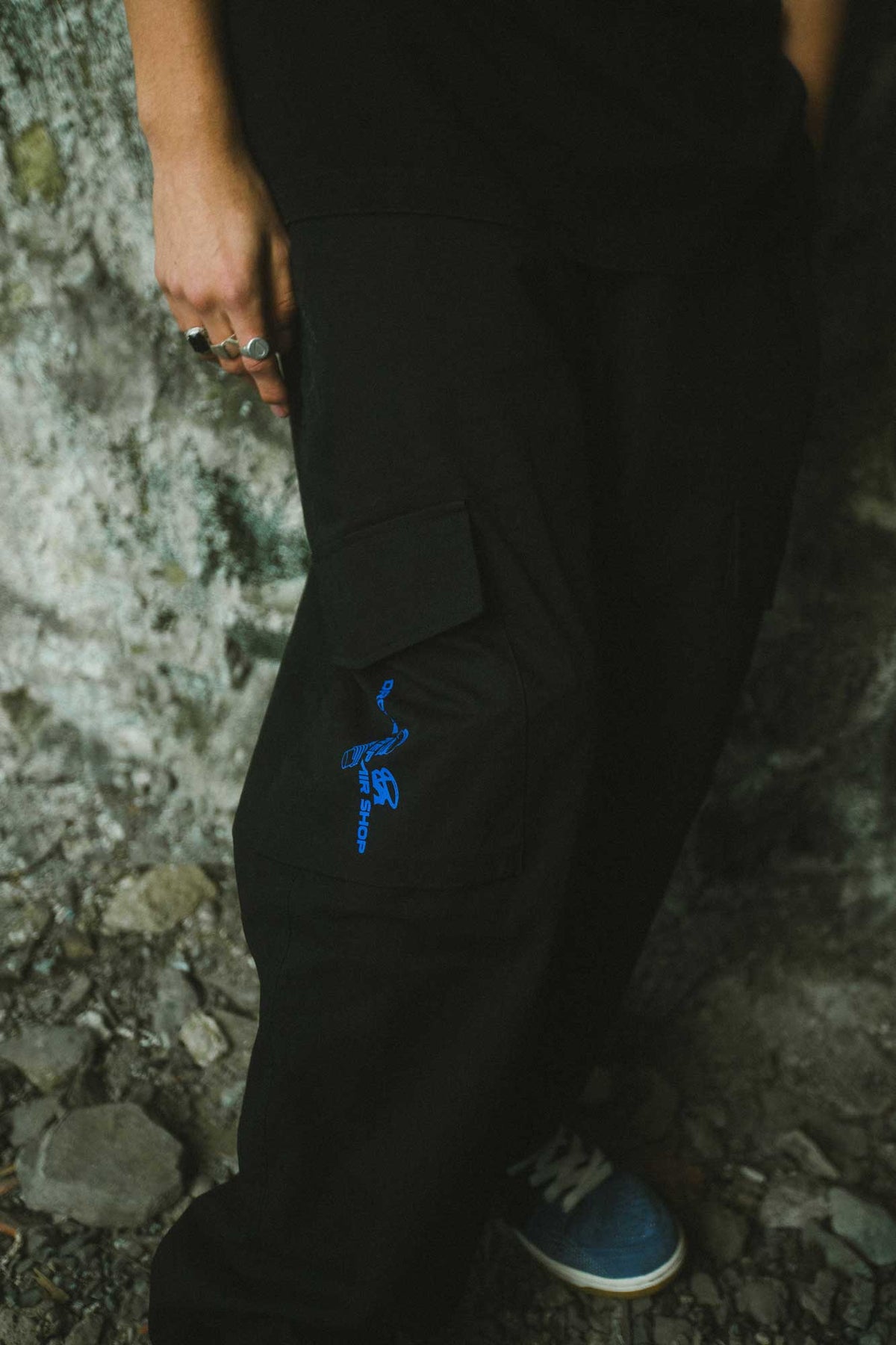 Alan Walker Drone Repair Shop Cargo Pants worn outdoors, close-up of the blue drone print on the side pocket