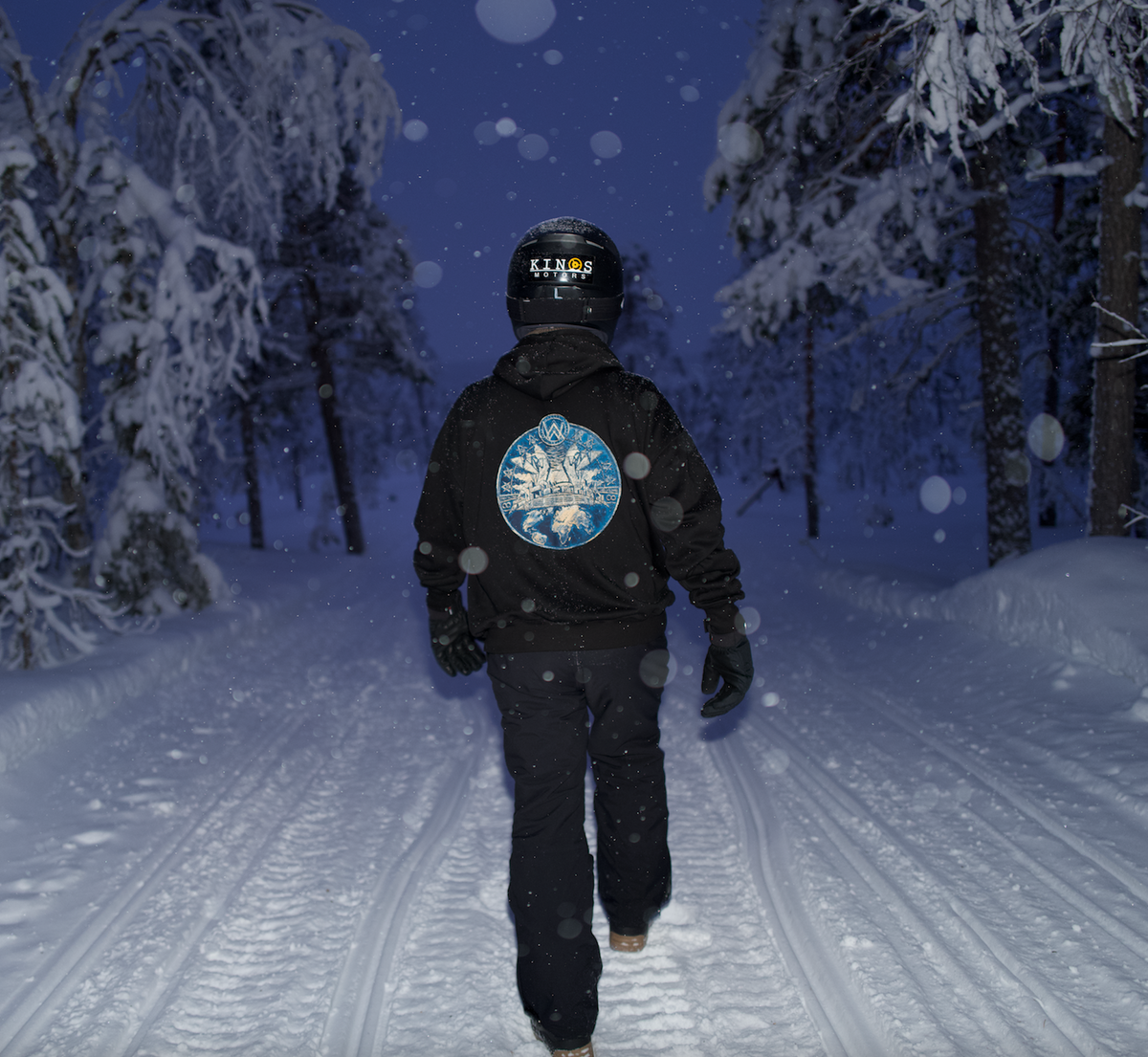 Alan Walker Prophecy Disc VIII Hoodie worn in a snowy forest, helmeted rider showing the blue disc back print