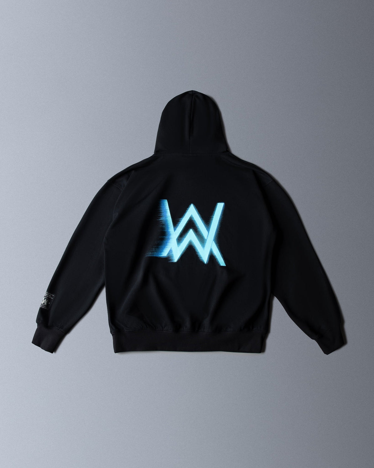 Alan Walker WRL Speed Hoodie in black, back flat lay with a blue motion blurred AW logo across the shoulders