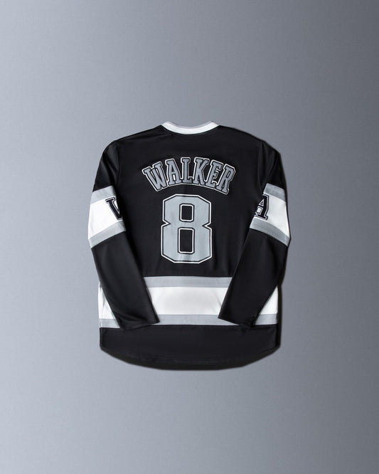 Alan Walker 8 Hockey Jersey back flat lay, black with grey Walker nameplate, number 8 and white stripes