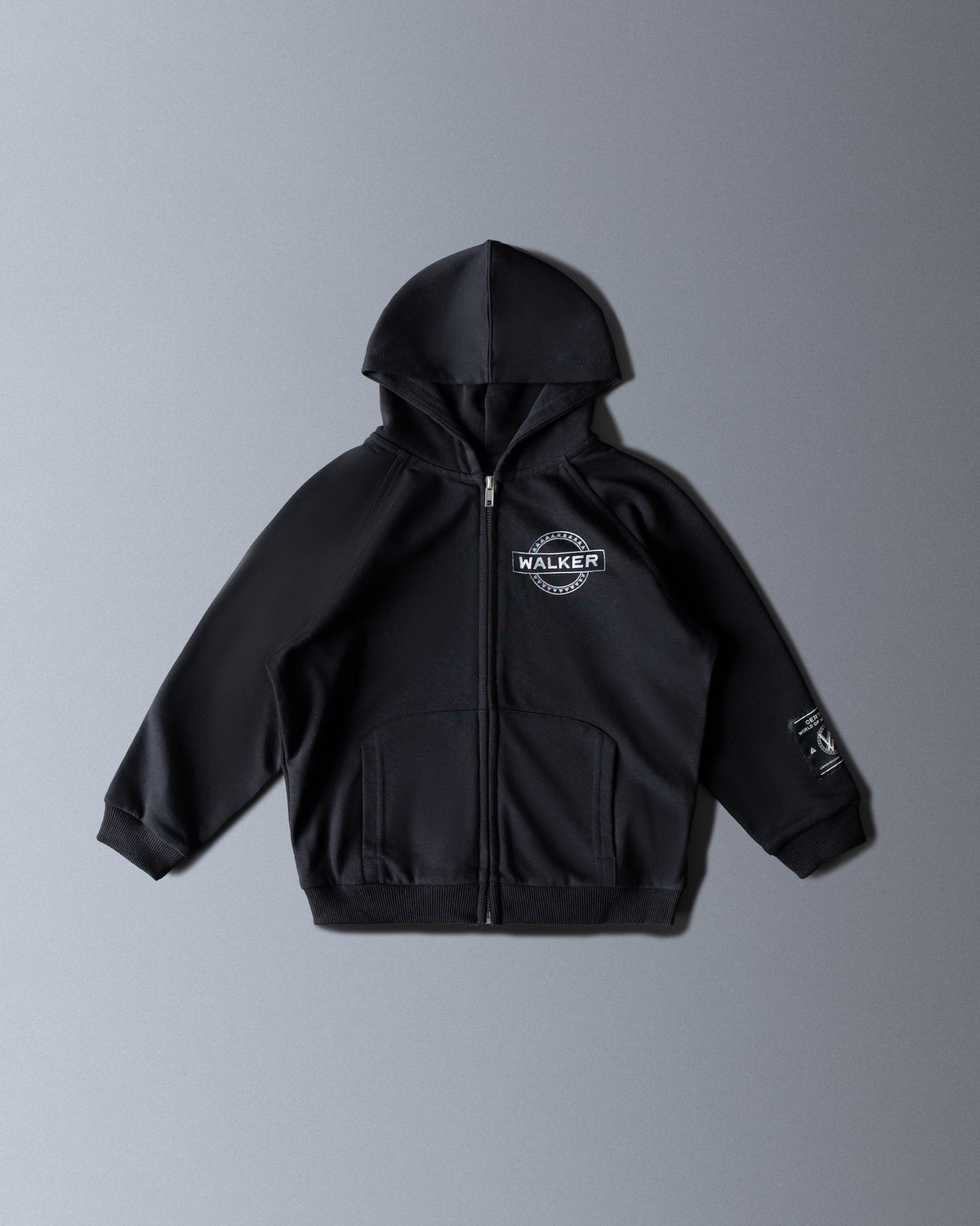 Alan Walker Monster Core Kids Zip Hoodie in black, front view with Walker crest chest logo and sleeve print