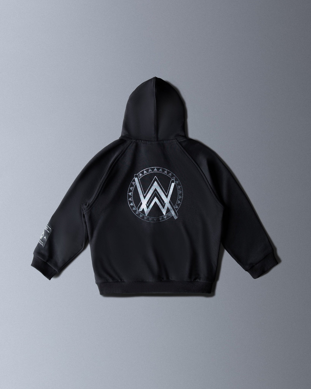 Alan Walker Monster Core Kids Zip Hoodie back flat lay in black with the silver AW crest inside a runic circle
