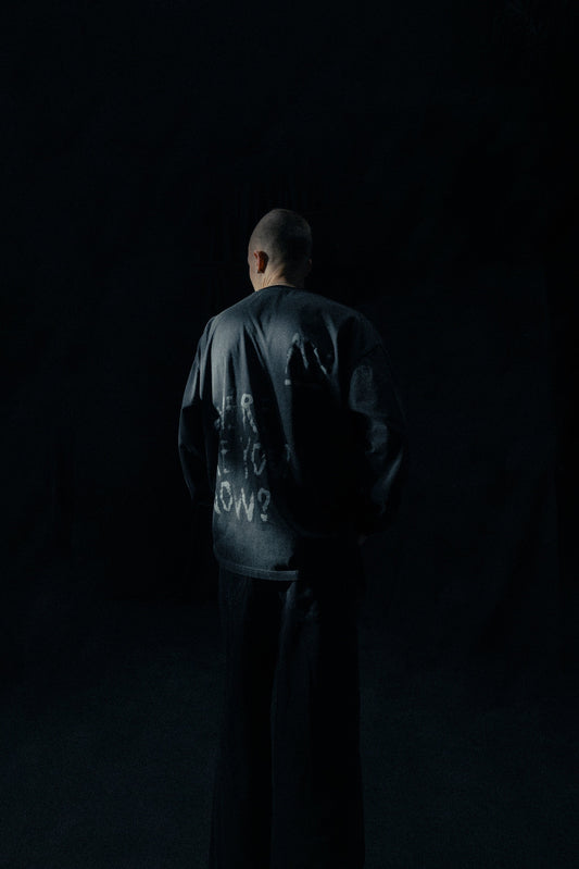 Alan Walker Faded Graffiti Longsleeve worn by a model from behind in a dark studio, glowing grey back print