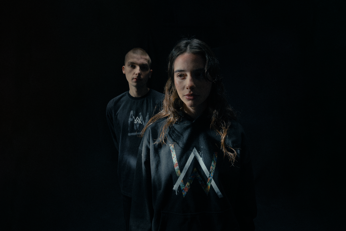 Alan Walker Tired 0 Hoodie on two models in shadow, matching black hoodies with the colour-filled AW logo