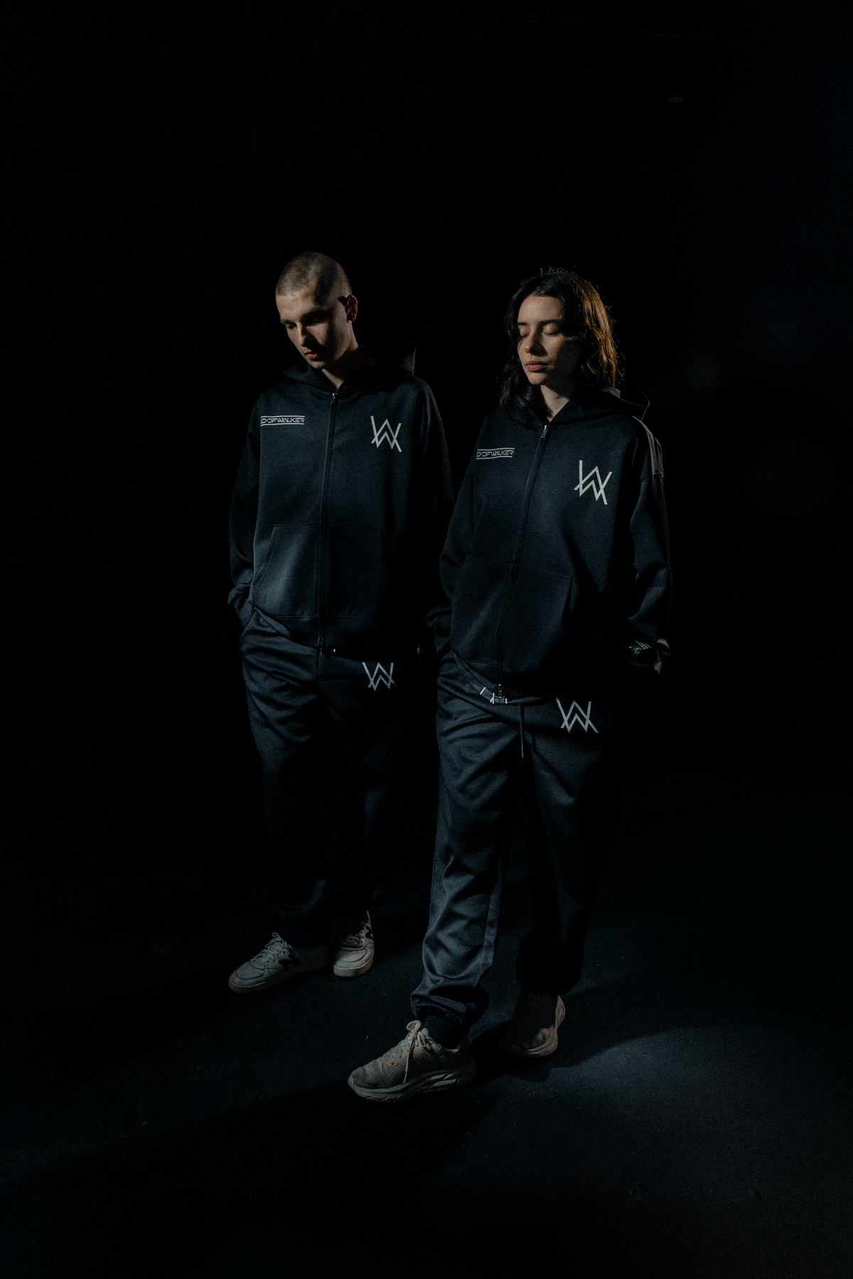 Alan Walker World of Walker Skyline Sweatpants on two models in low light, full black Walker tracksuit look