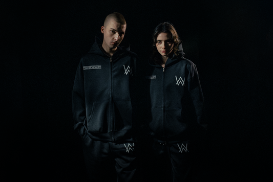 Alan Walker World of Walker Skyline Bundle worn by two models in the dark, matching black zip hoodies and joggers