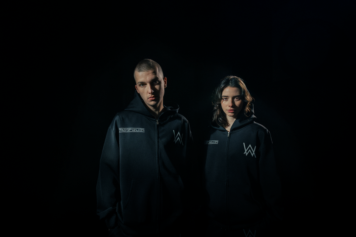 Alan Walker World of Walker Skyline Zip Hoodie on two models in the dark, matching black Walker fan zip hoodies