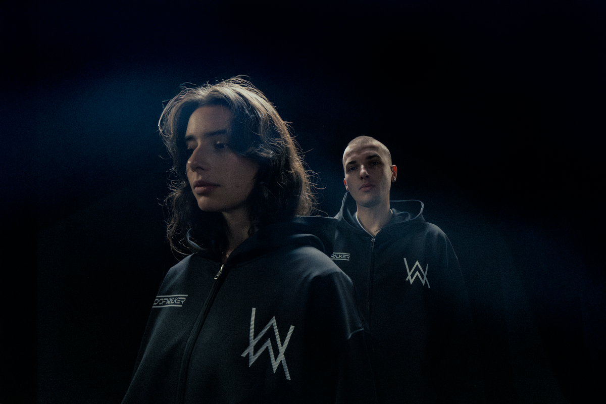 Alan Walker World of Walker Skyline Bundle on two models lit in blue, black hoodies with reflective AW logos