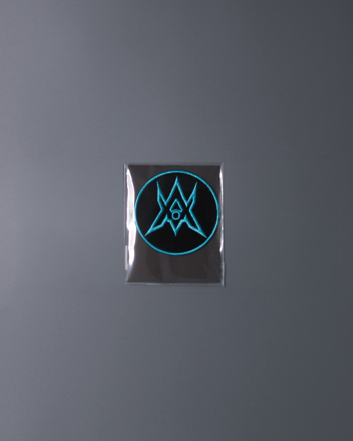 Alan Walker Unity Force Tribe Patch sealed in clear packaging, circular cyan crest badge on grey backdrop