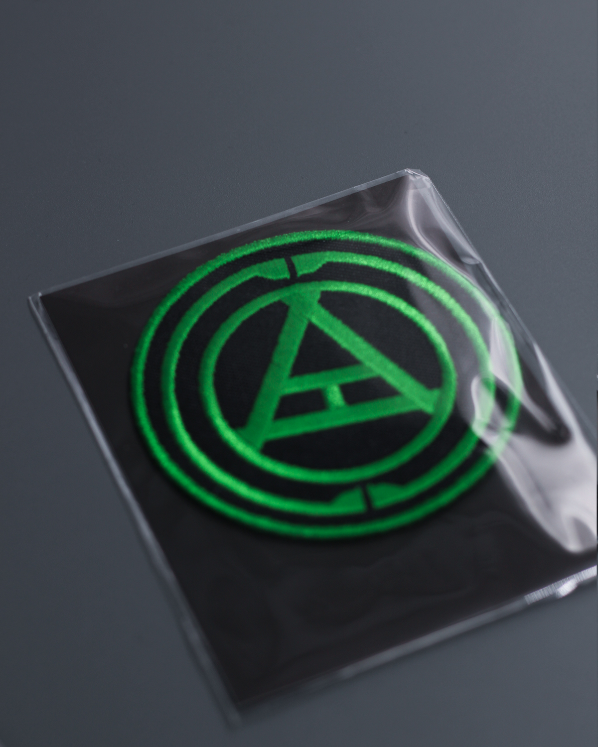 Alan Walker Creator Circle Tribe Bundle patch in a clear pack, green circular emblem on black backing