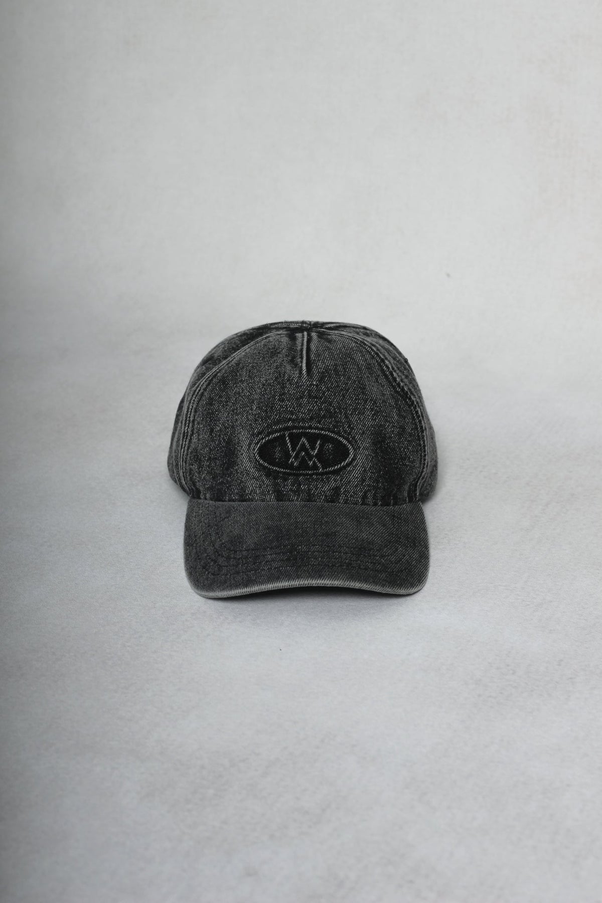 Alan Walker Washed Logo Cap in washed black denim, front view with tonal embroidered AW oval logo patch