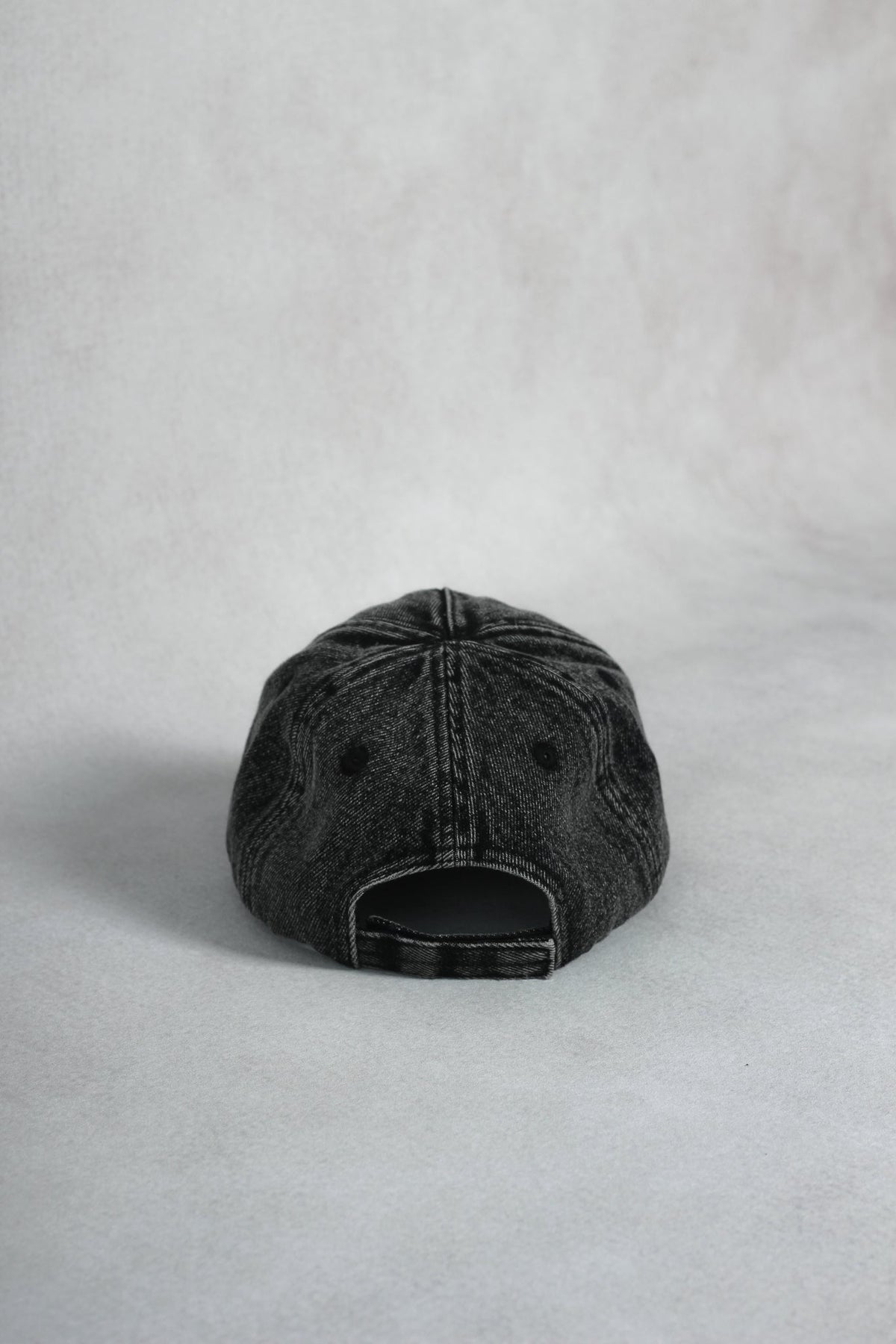 Alan Walker Washed Logo Cap rear view showing adjustable strap closure and vintage washed black fabric