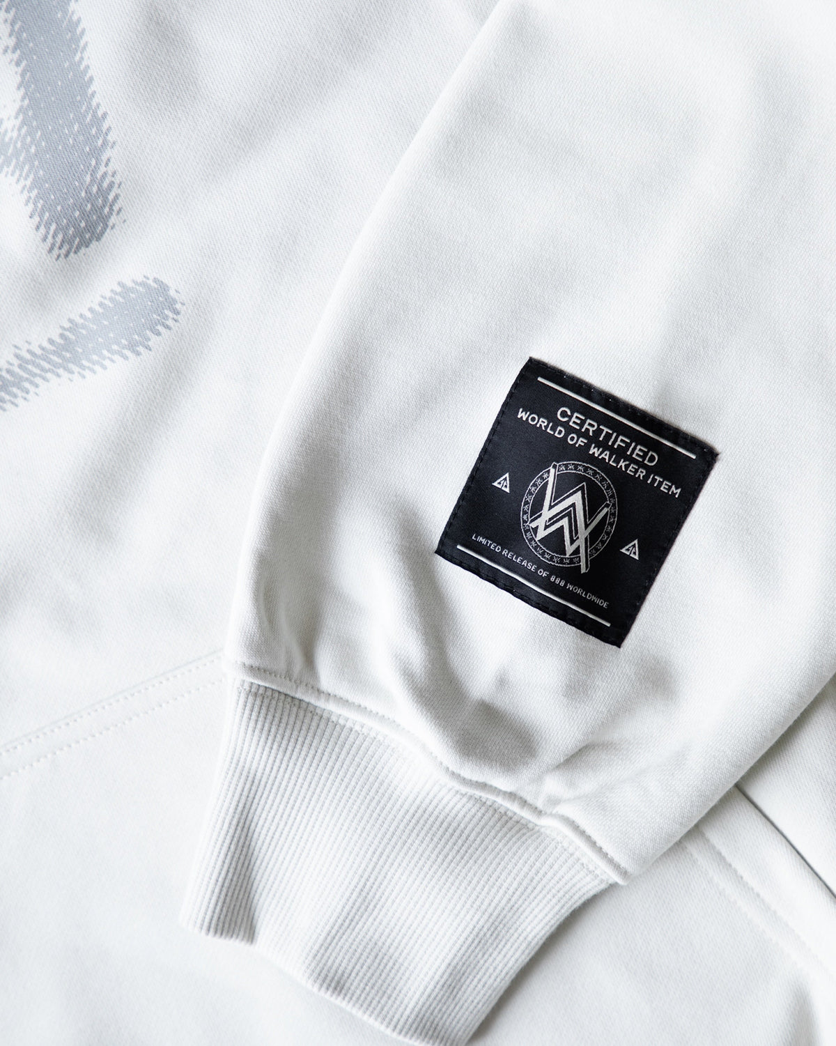 Alan Walker Faded Graffiti Hoodie off white hem detail with the black woven World of Walker label