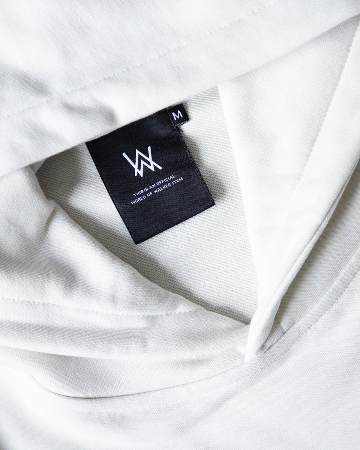 Alan Walker Faded Graffiti Hoodie off white hood close-up with the black AW inner size label