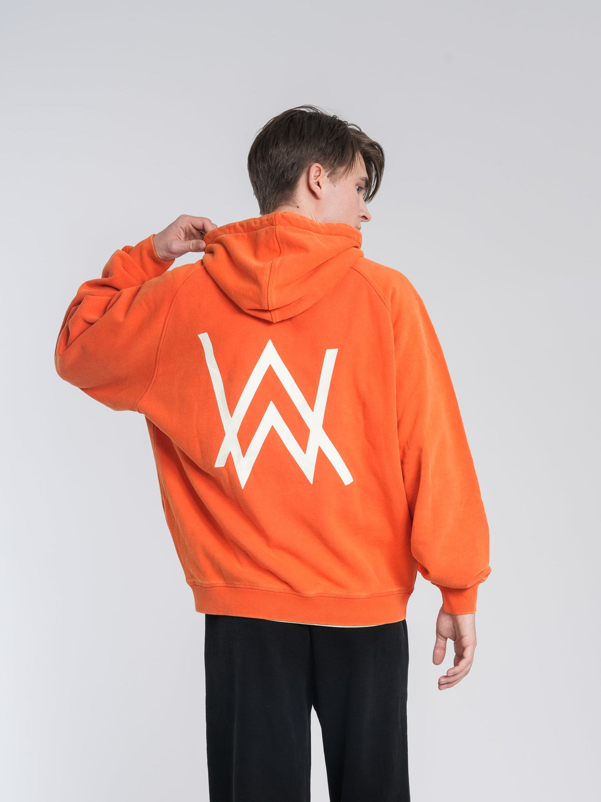 Alan Walker Walkerworld Logo Hoodie rear view on a model, crisp white AW logo printed on orange cotton fleece