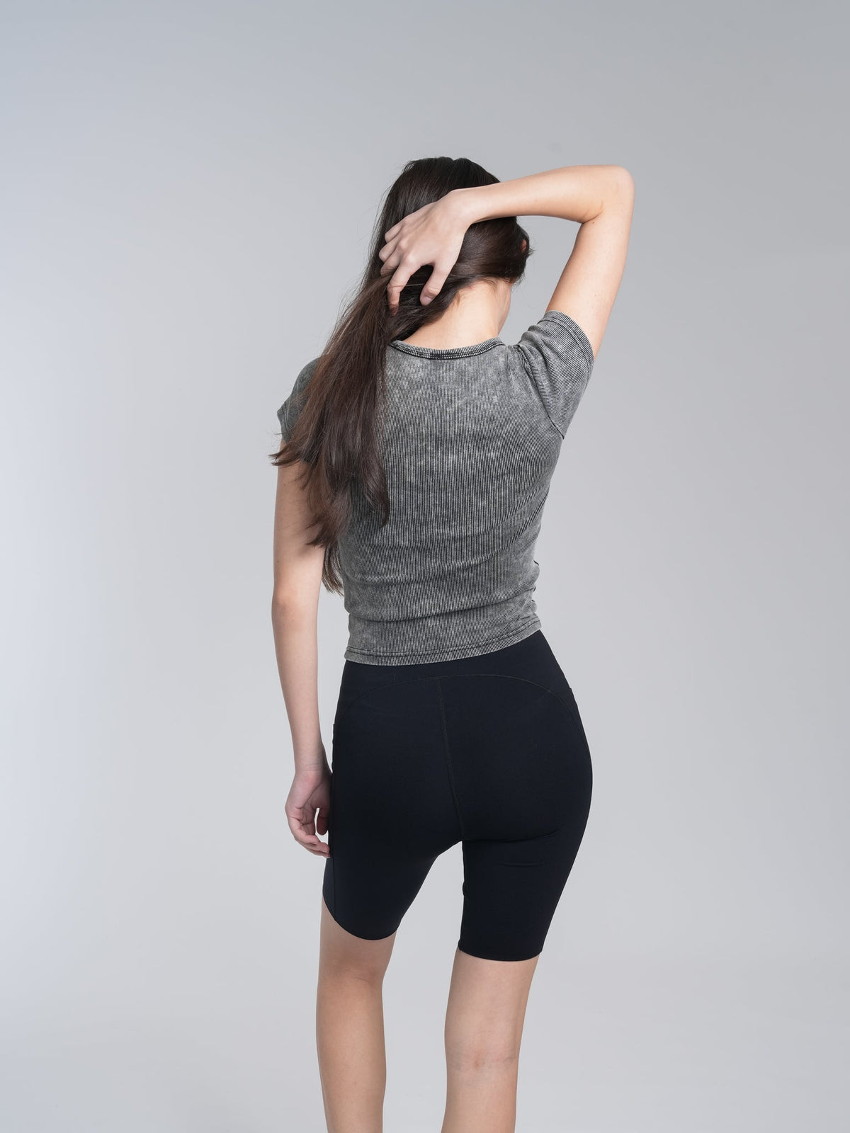 Alan Walker Washed Fitted Tee back view on a model, washed grey fitted top with acid wash finish across the shoulders