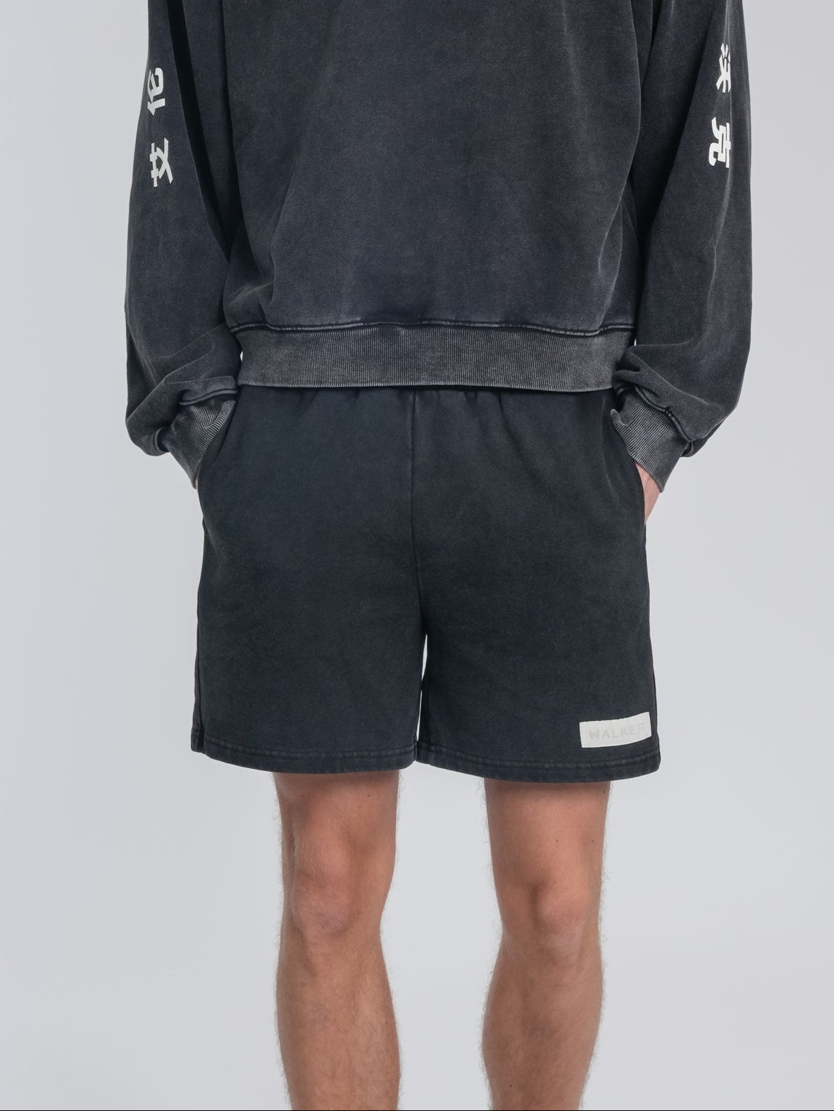 Alan Walker Crew Washed Alan Shorts worn by a model, back view in washed black with a small woven hem label
