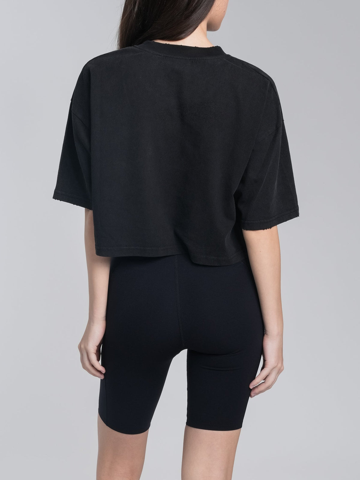 Alan Walker Cropped Tee back view on a model, plain black cropped silhouette with a wide relaxed body