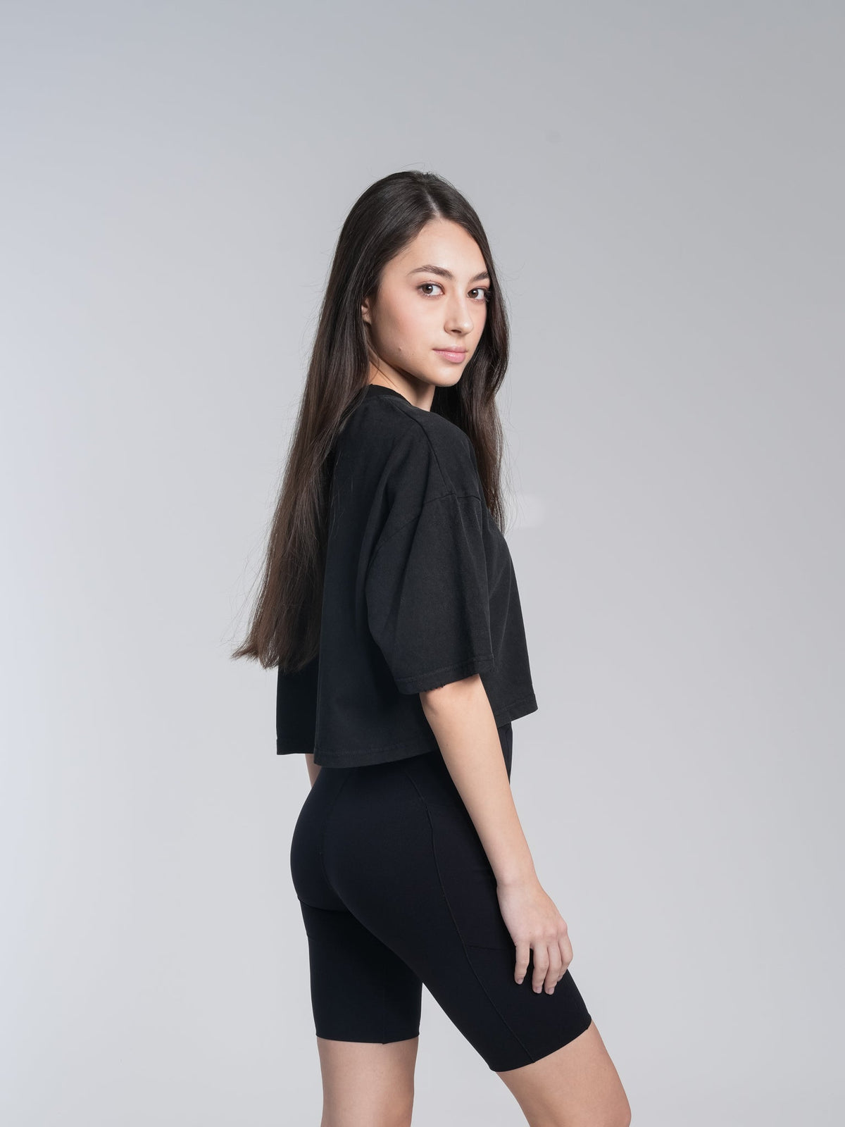 Alan Walker Cropped Tee side view on a model, showing the short boxy cut and dropped elbow sleeves