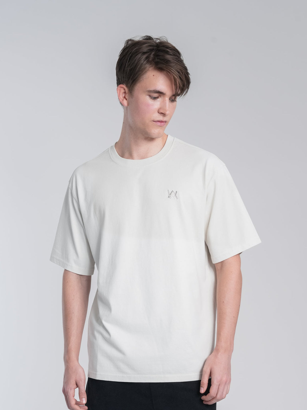 Alan Walker Off-White Walker Tee front view worn by a model, boxy off-white tee with small AW chest logo