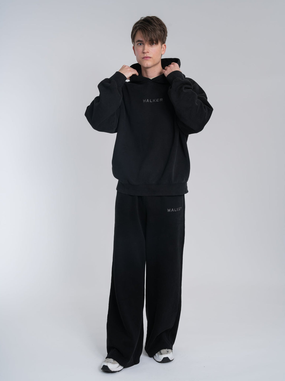 Alan Walker Core Hoodie front on a male model, black hood up with matching Walker Core sweatpants