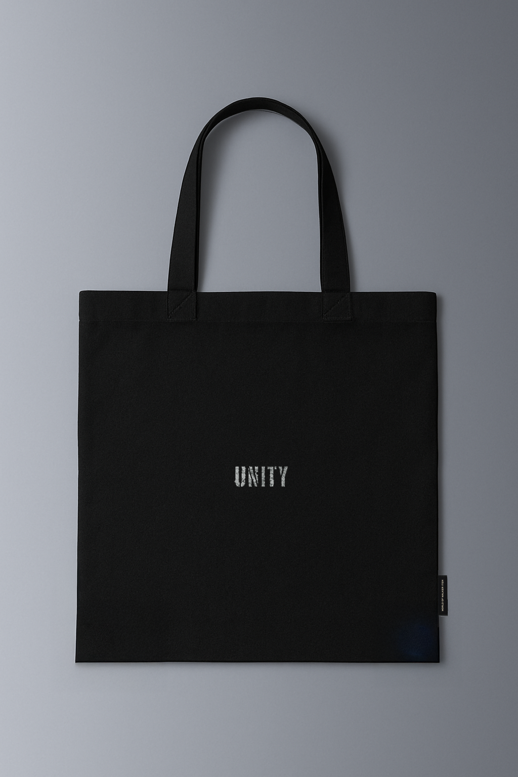 Alan Walker Tired Unity Tote back view, black canvas shopper with a small tonal Unity wordmark print