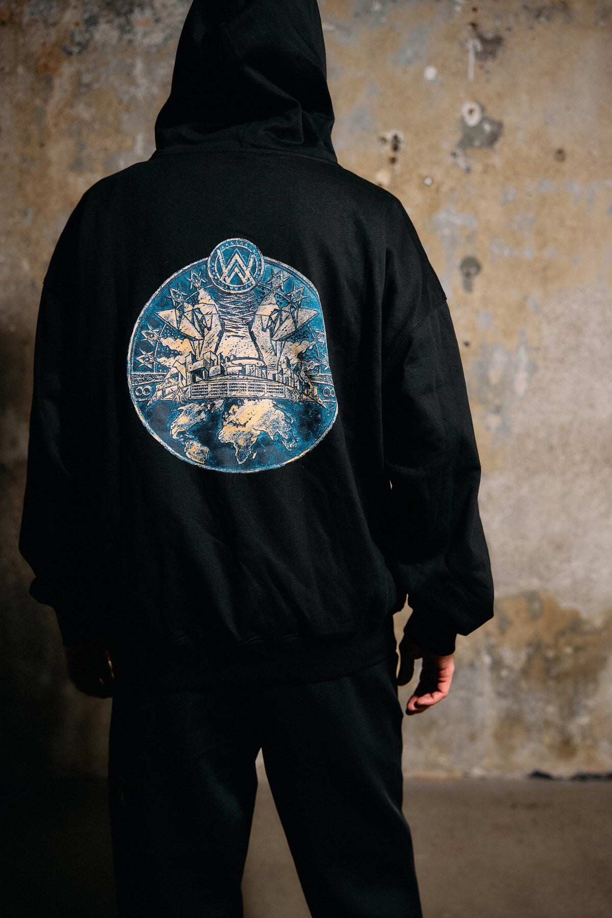 Alan Walker Prophecy Disc VIII Hoodie worn from behind outdoors, glowing blue prophecy disc back graphic