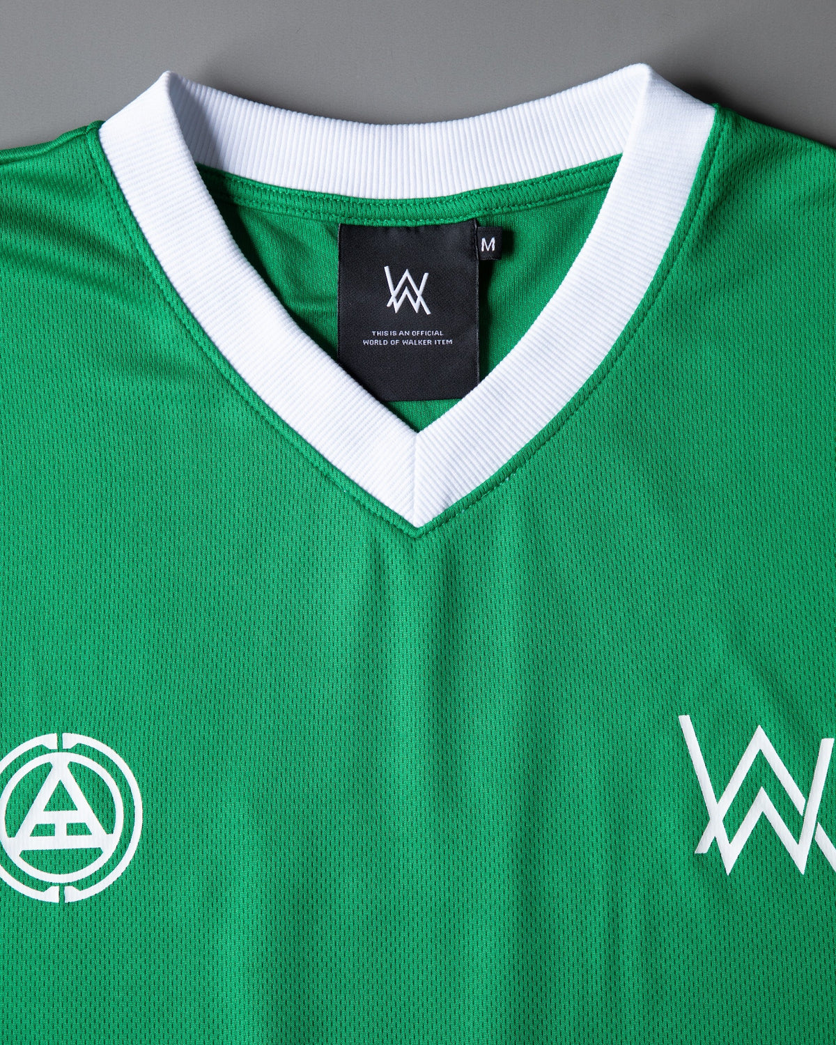 Alan Walker Creator Circle Tribe Jersey folded flat in green, white ribbed V-neck with the black World of Walker neck label