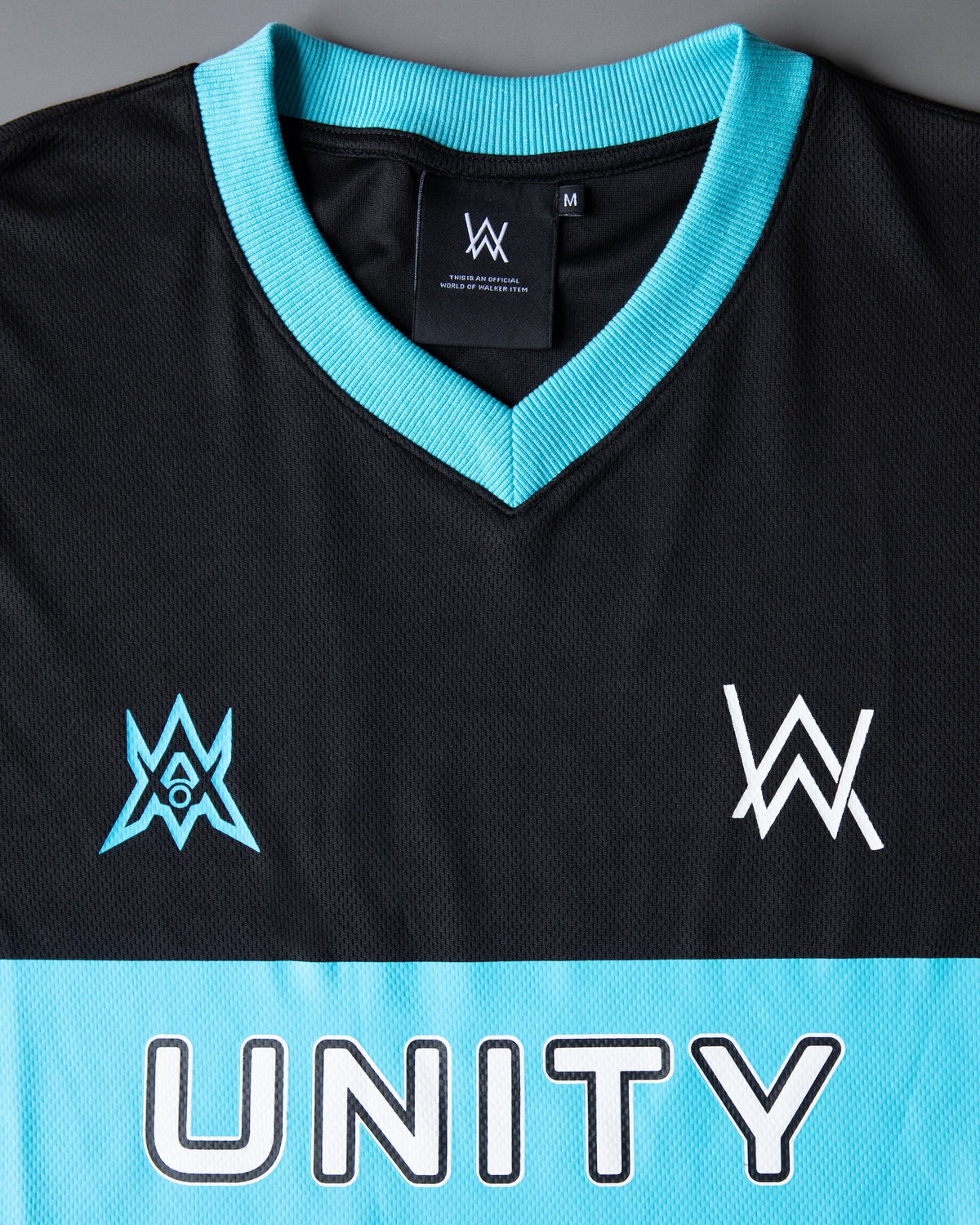 Alan Walker Unity Force Tribe Jersey chest detail, cyan star crest and white AW logo above the Unity band