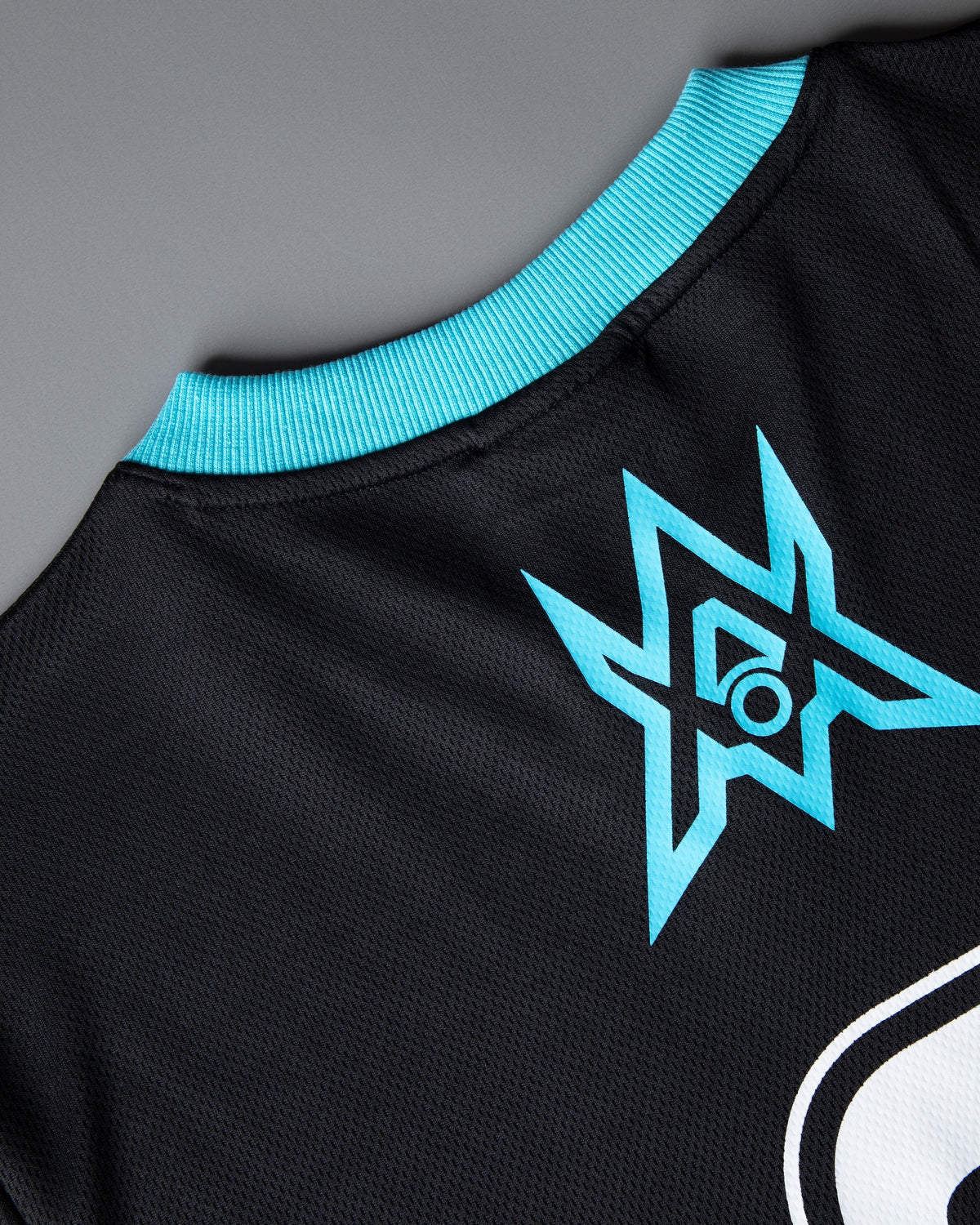 Alan Walker Unity Force Tribe Jersey fabric close-up, cyan tribe star emblem printed on black mesh knit