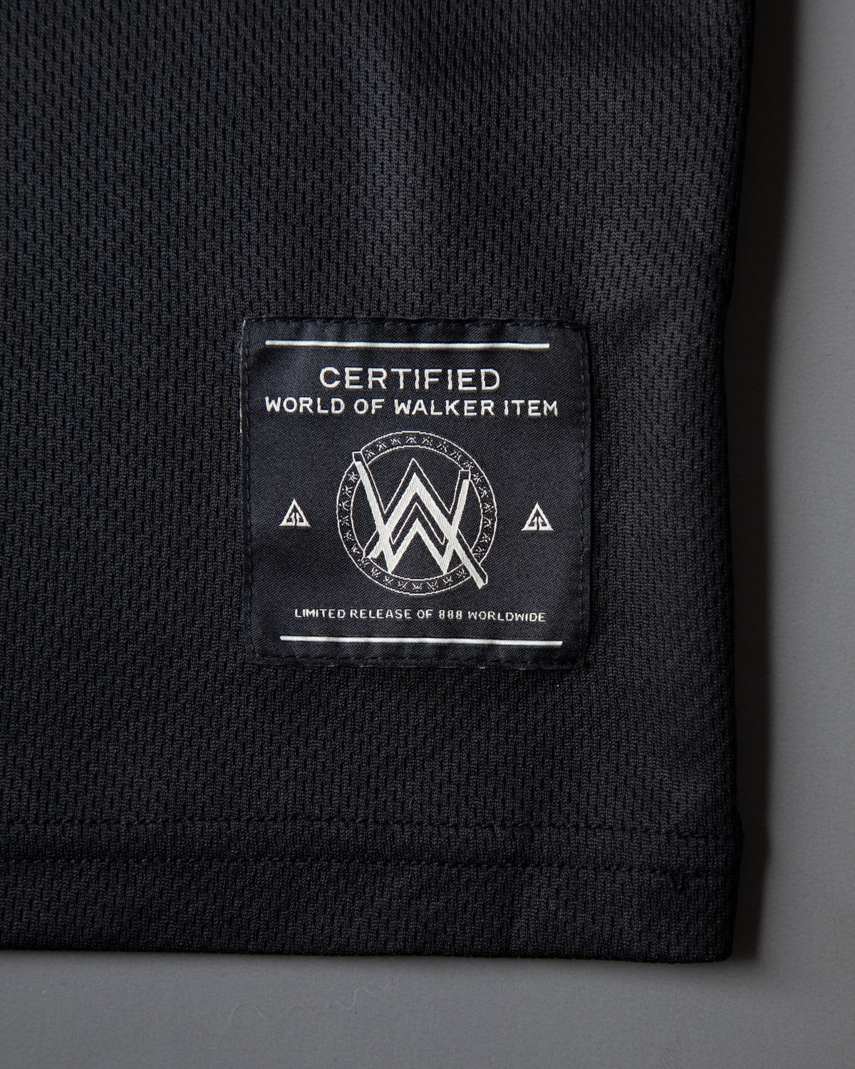 Alan Walker Unity Force Tribe Jersey hem tag reading World of Walker Item on black mesh fabric