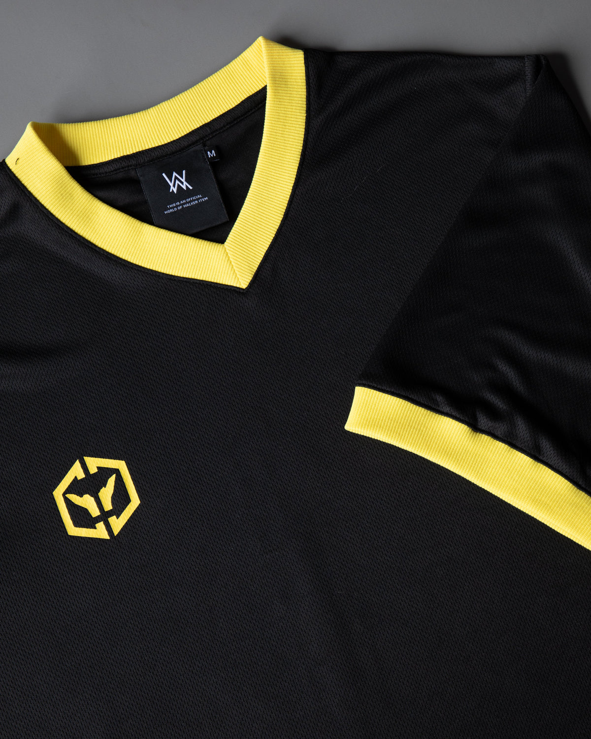 Alan Walker CheckPoint One Tribe Jersey collar detail, yellow ribbed V-neck with a woven AW size M label