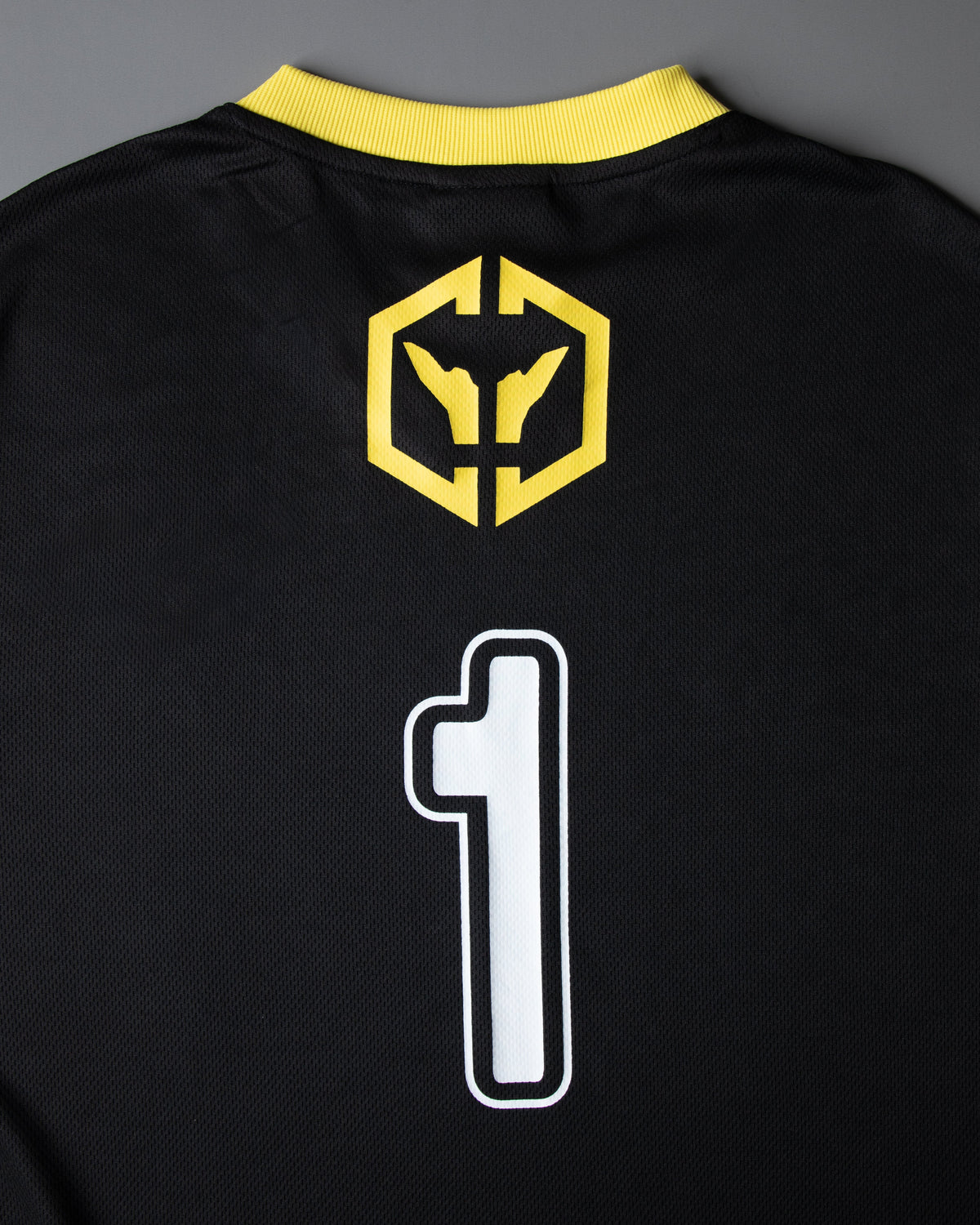 Alan Walker CheckPoint One Tribe Jersey back detail, yellow hex crest above the white outlined number 1