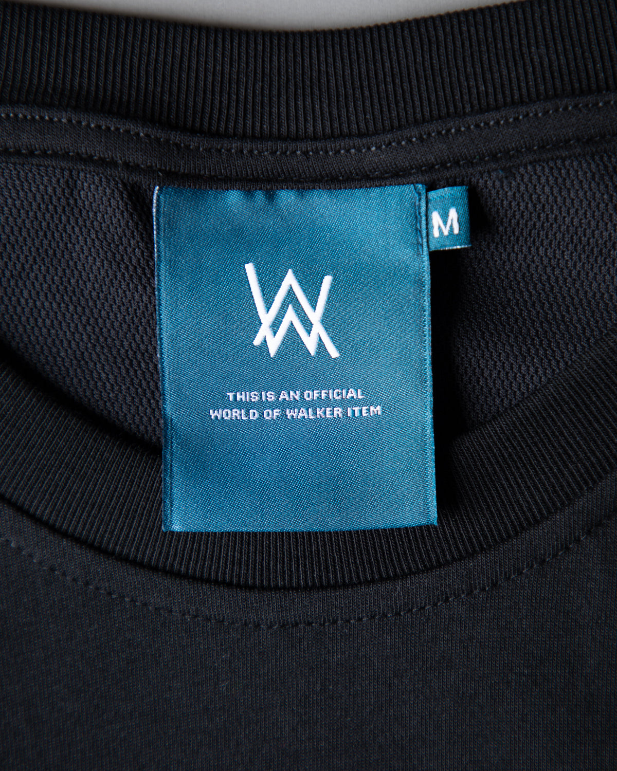 Alan Walker Springseeker Sports T-Shirt neckline detail, ribbed black collar with teal Walker size tag