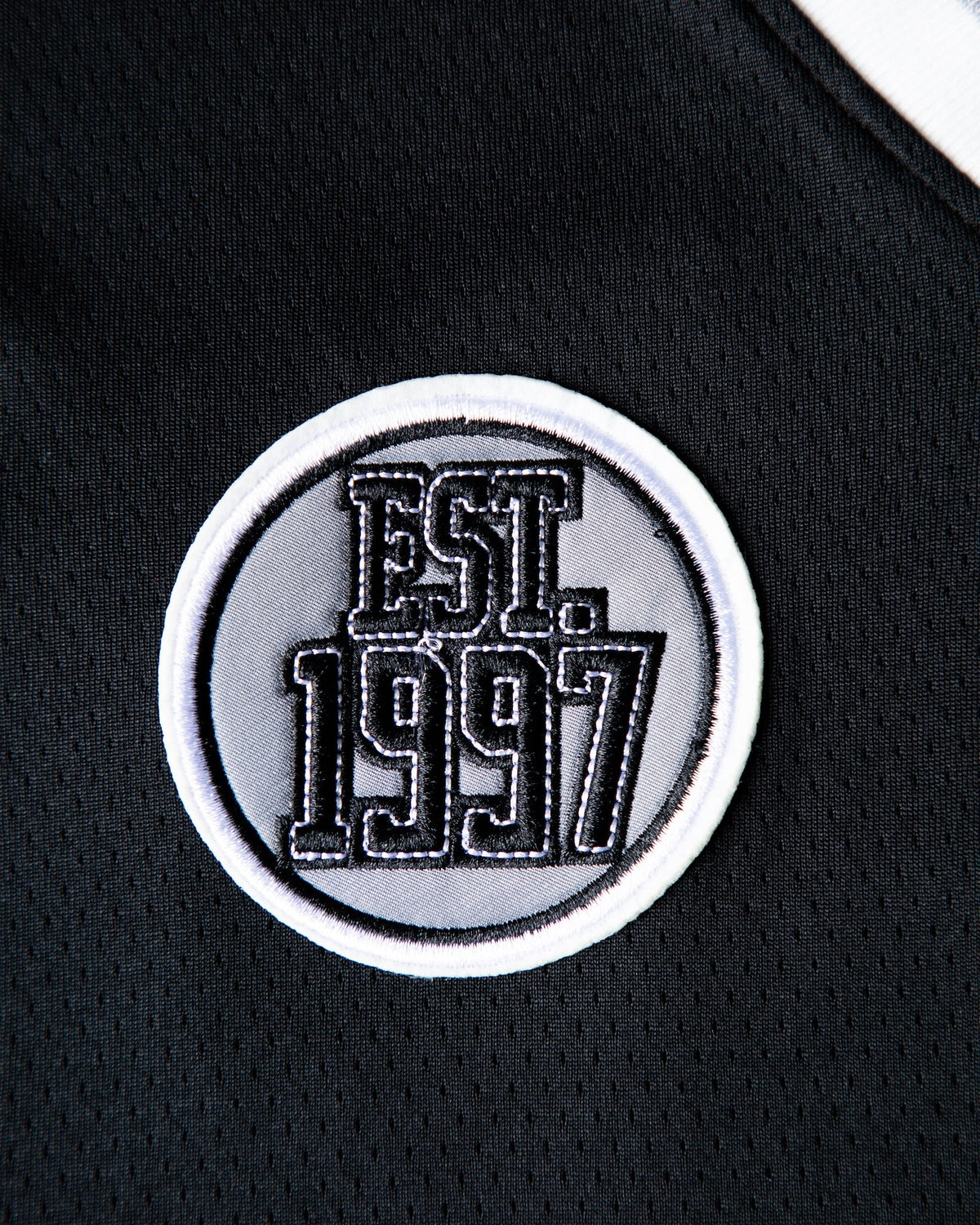 Alan Walker 8 Hockey Jersey patch close-up, embroidered Est 1997 varsity roundel on black mesh fabric