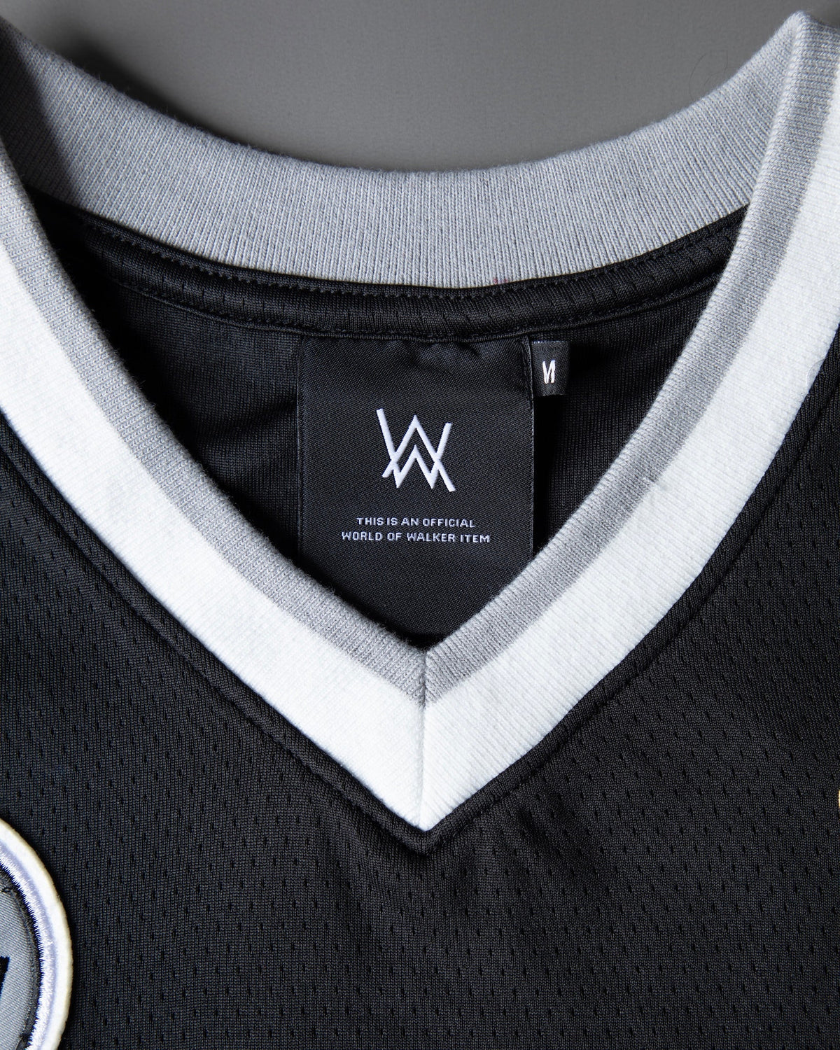 Alan Walker 8 Hockey Jersey collar close-up with layered grey and white V-neck rib and AW inner label