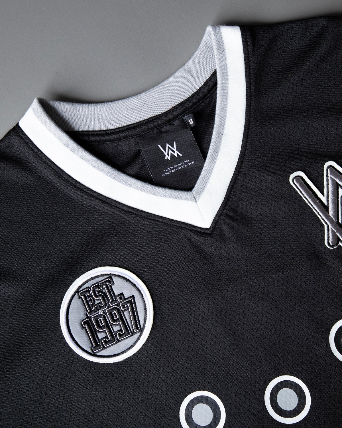 Alan Walker 8 Hockey Jersey angled front view showing the Est 1997 badge and grey ring graphics on black