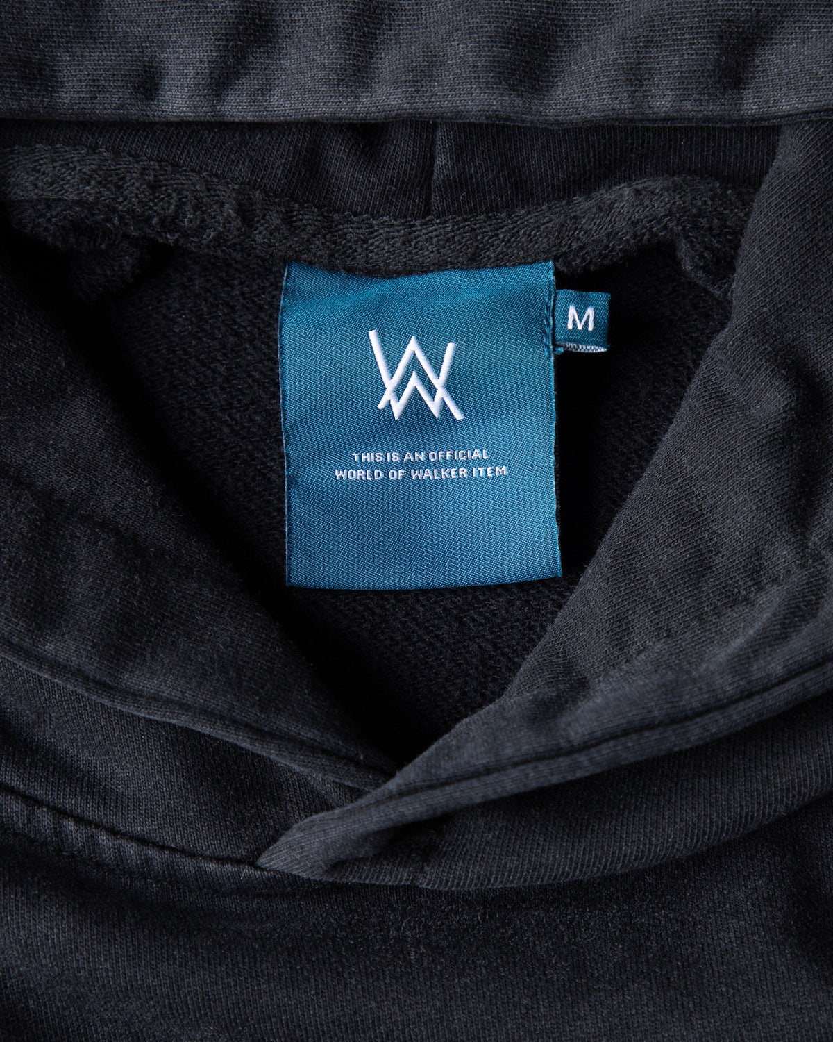 Alan Walker Heading Home Hoodie hood close-up with the teal World of Walker label sewn inside the neck