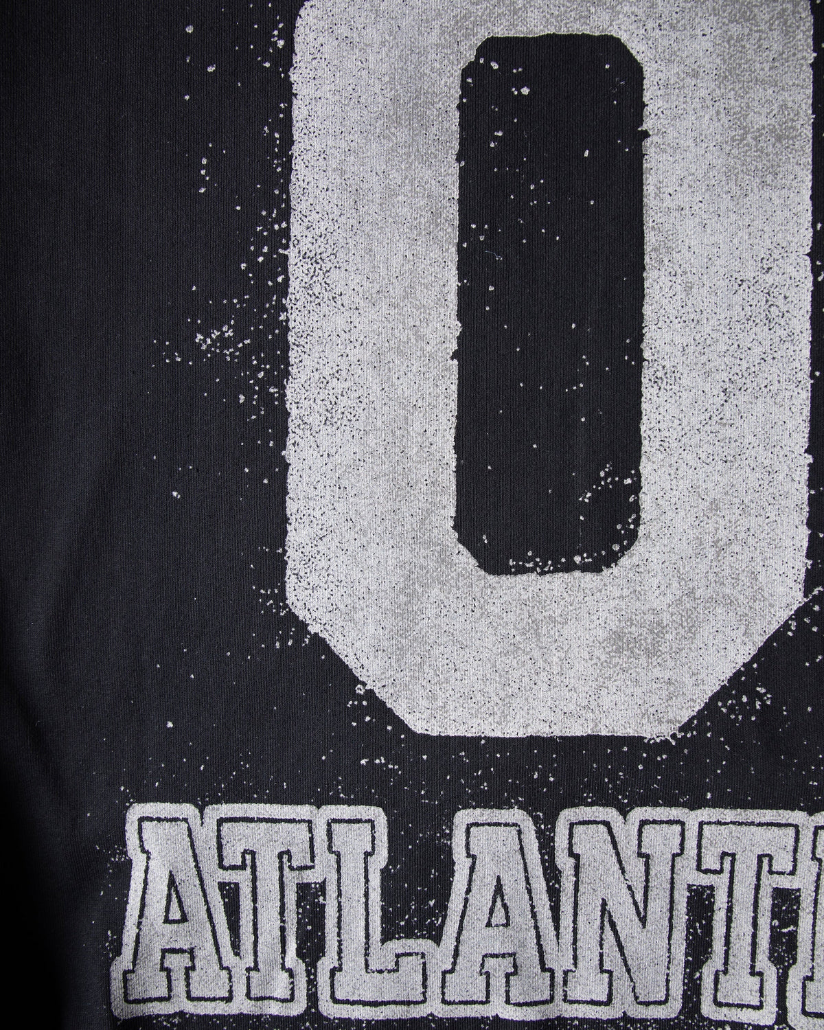 Alan Walker Atlantis 0 Hoodie back print close-up, cracked white varsity 0 above bold Atlantis lettering