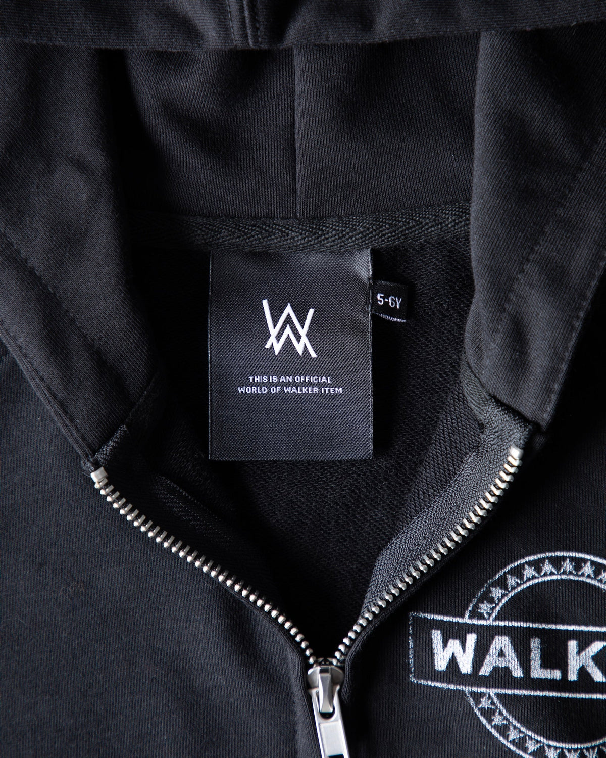 Alan Walker Monster Core Kids Zip Hoodie inner neck label close-up, woven AW brand tag