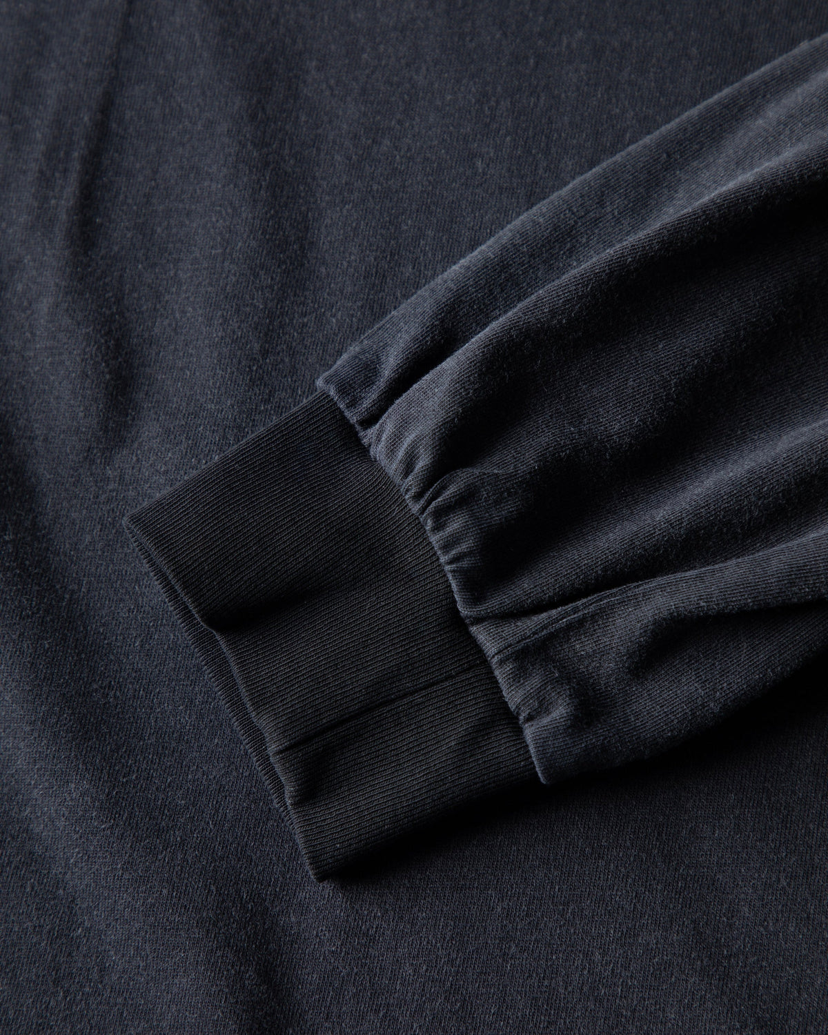 Alan Walker Heading Home Longsleeve sleeve close-up showing the ribbed cuff on soft black cotton