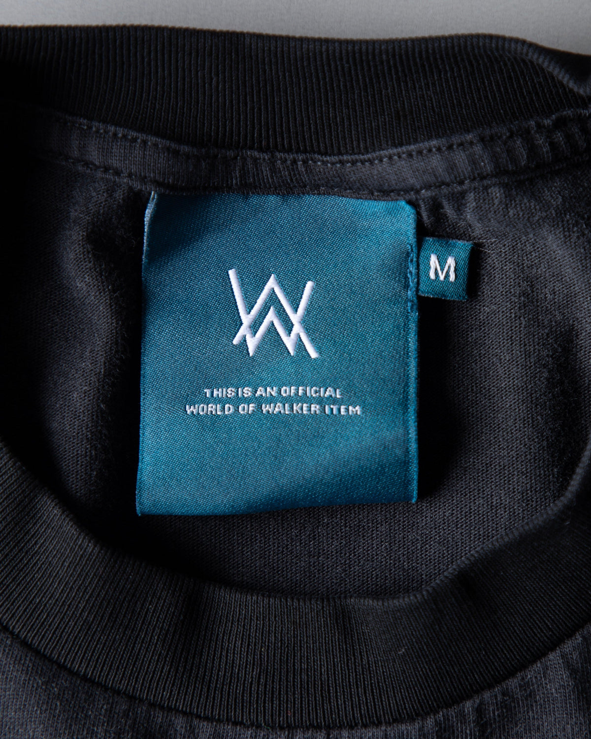 Alan Walker Heading Home Longsleeve neck label detail, teal World of Walker tag inside the black collar