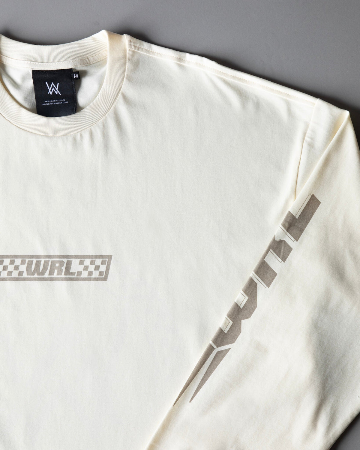 Alan Walker WRL Logo Longsleeve folded at an angle showing the WRL sleeve print in grey on cream fabric