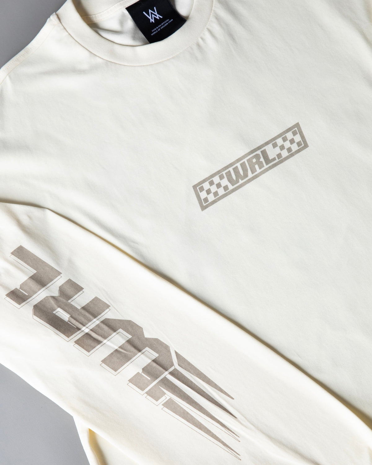 Alan Walker WRL Logo Longsleeve in cream laid flat, chest WRL checkered logo beside the speed blurred sleeve print