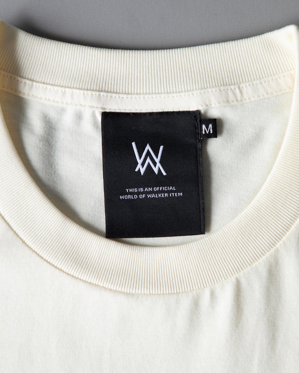 Alan Walker WRL Logo Longsleeve cream collar close-up with the World of Walker AW label stitched inside