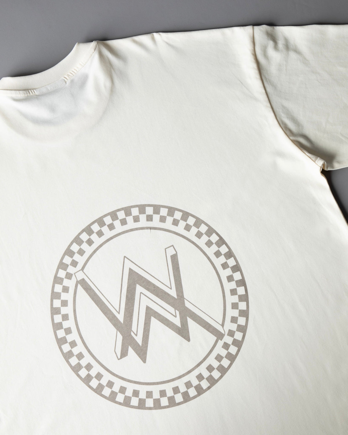 Alan Walker WRL Logo Longsleeve back detail, grey checkered ring surrounding the AW logo on cream jersey