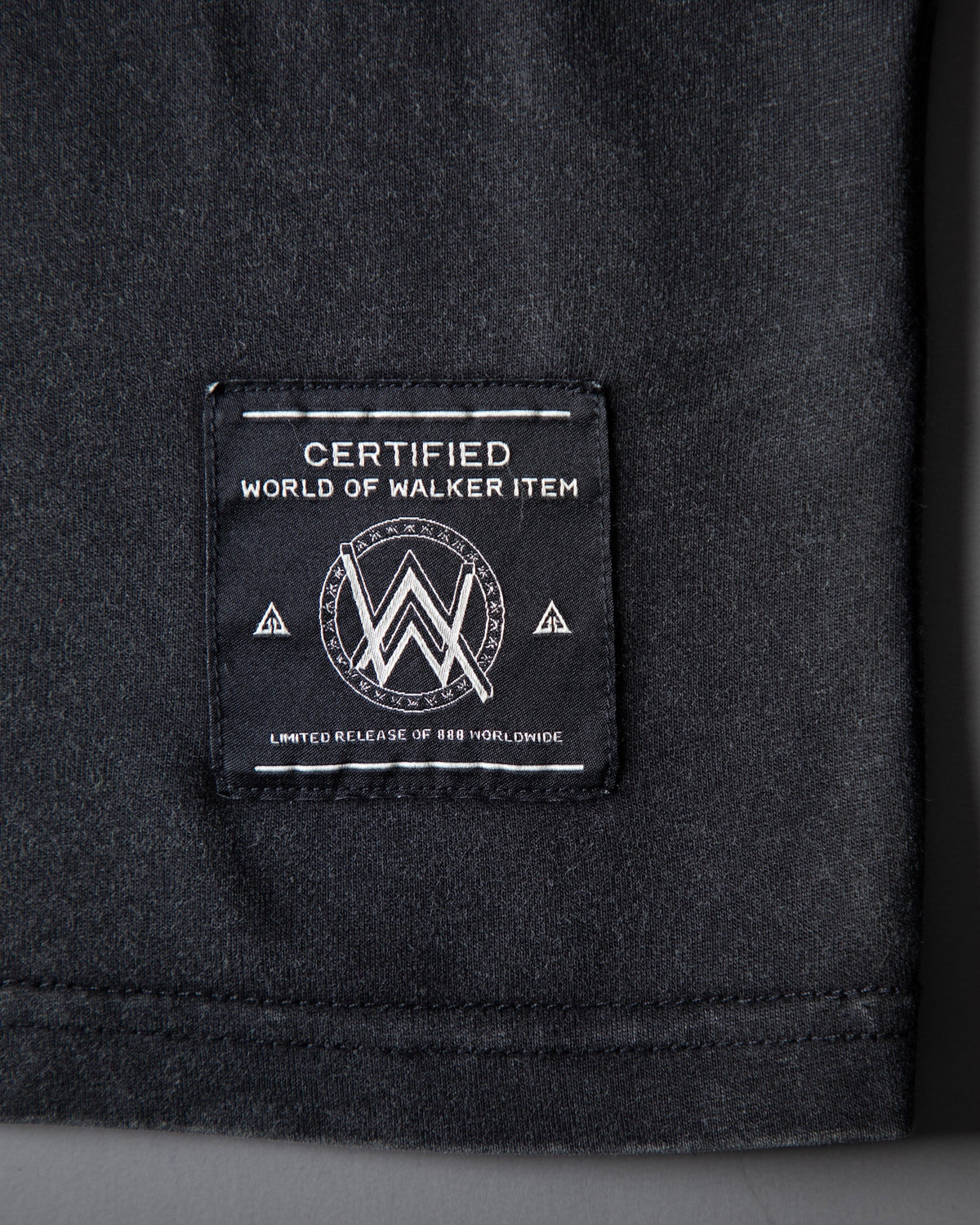 Alan Walker Rise Of The Drone Vintage T-Shirt hem detail, World of Walker woven label on black cotton
